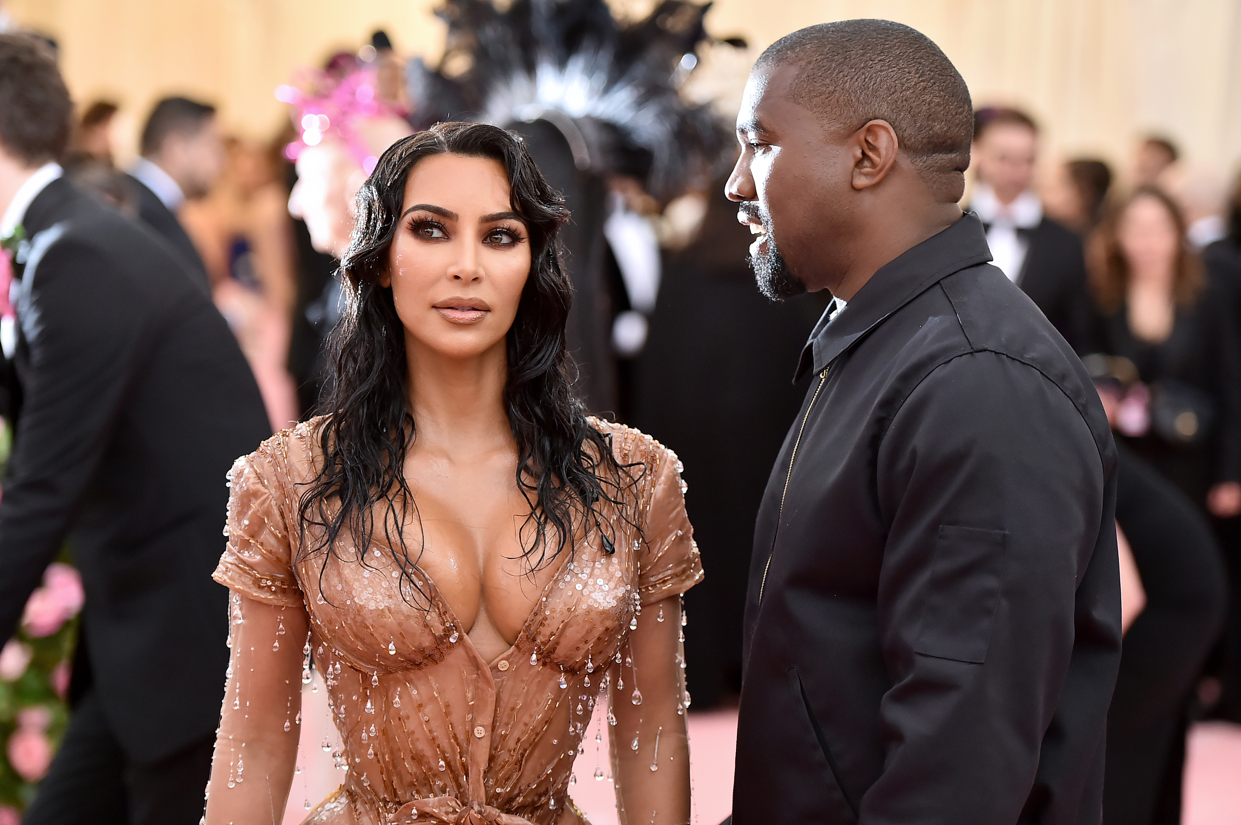 Close-up of Ye looking at Kim at a media event