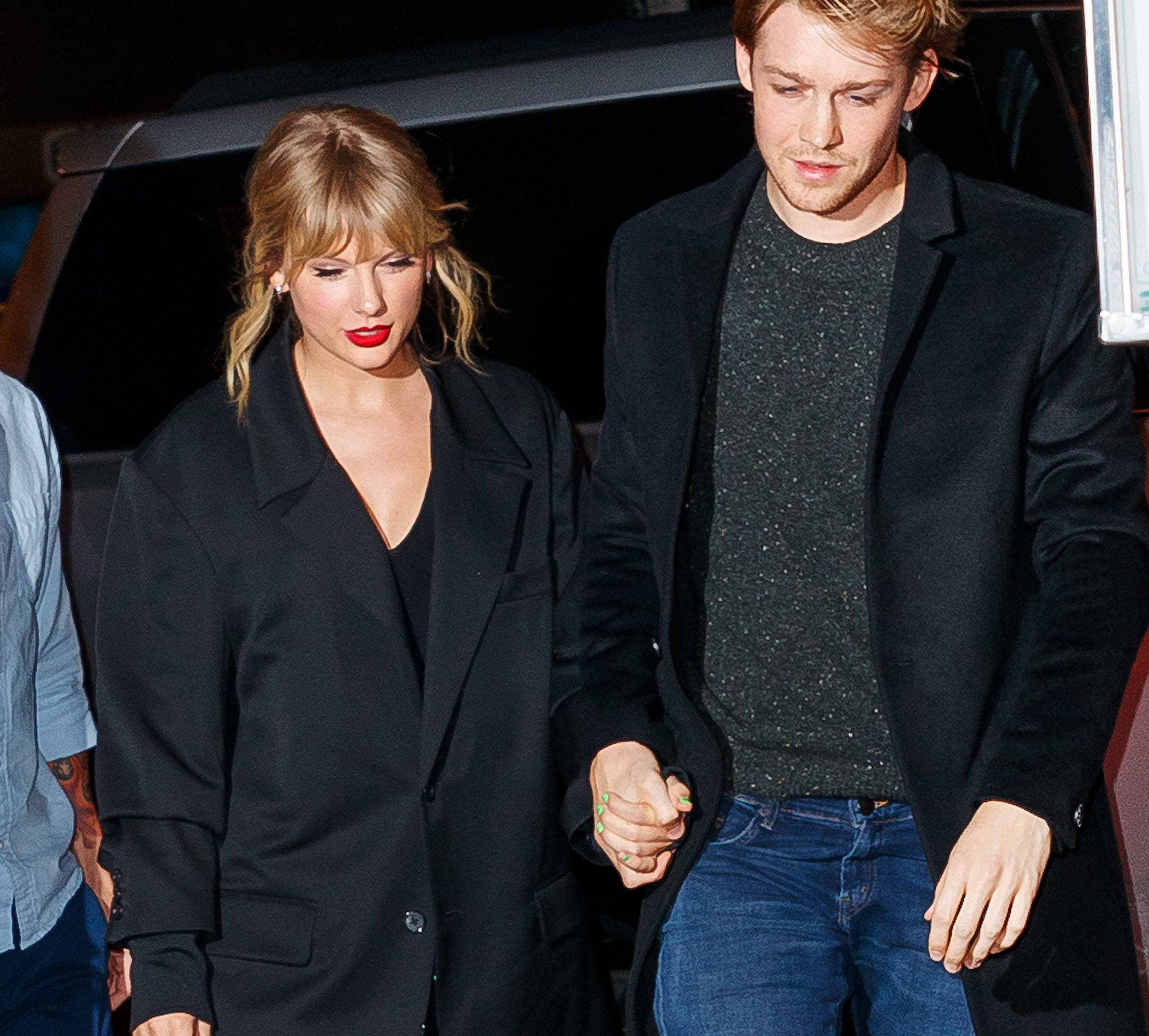 Close-up of Taylor and Joe holding hands