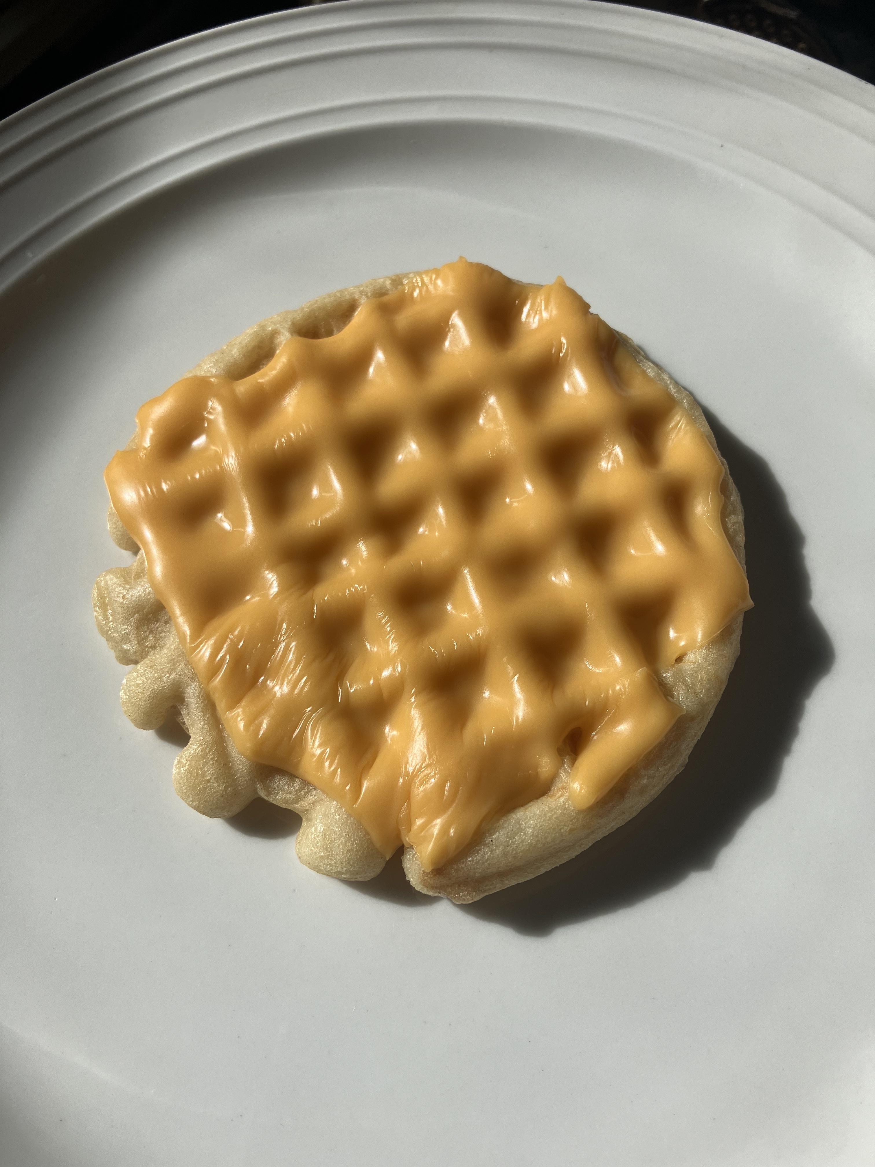 a kraft single melted onto an eggo waffle