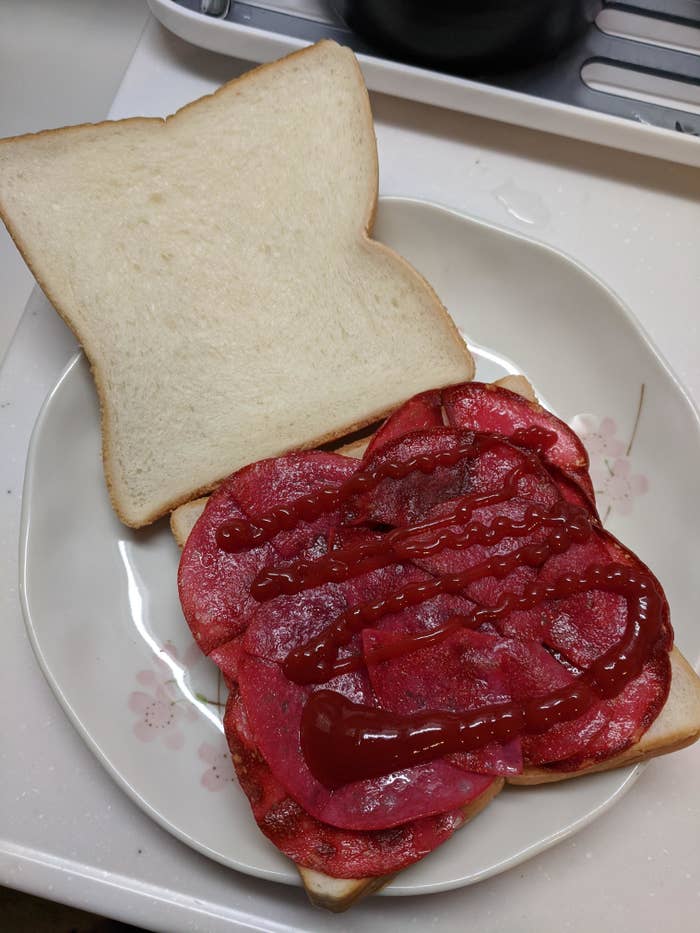 ketchup and bologna in between two slices of white bread