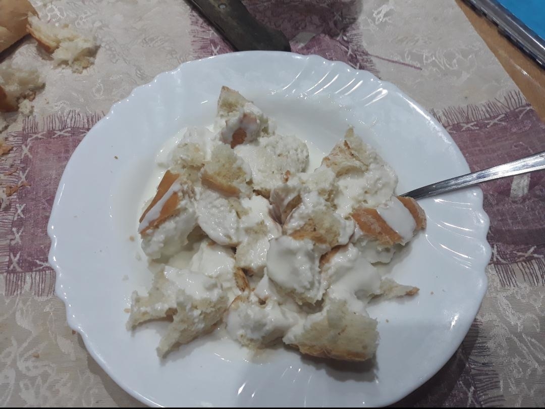 Torn pieces of bread in plain yogurt