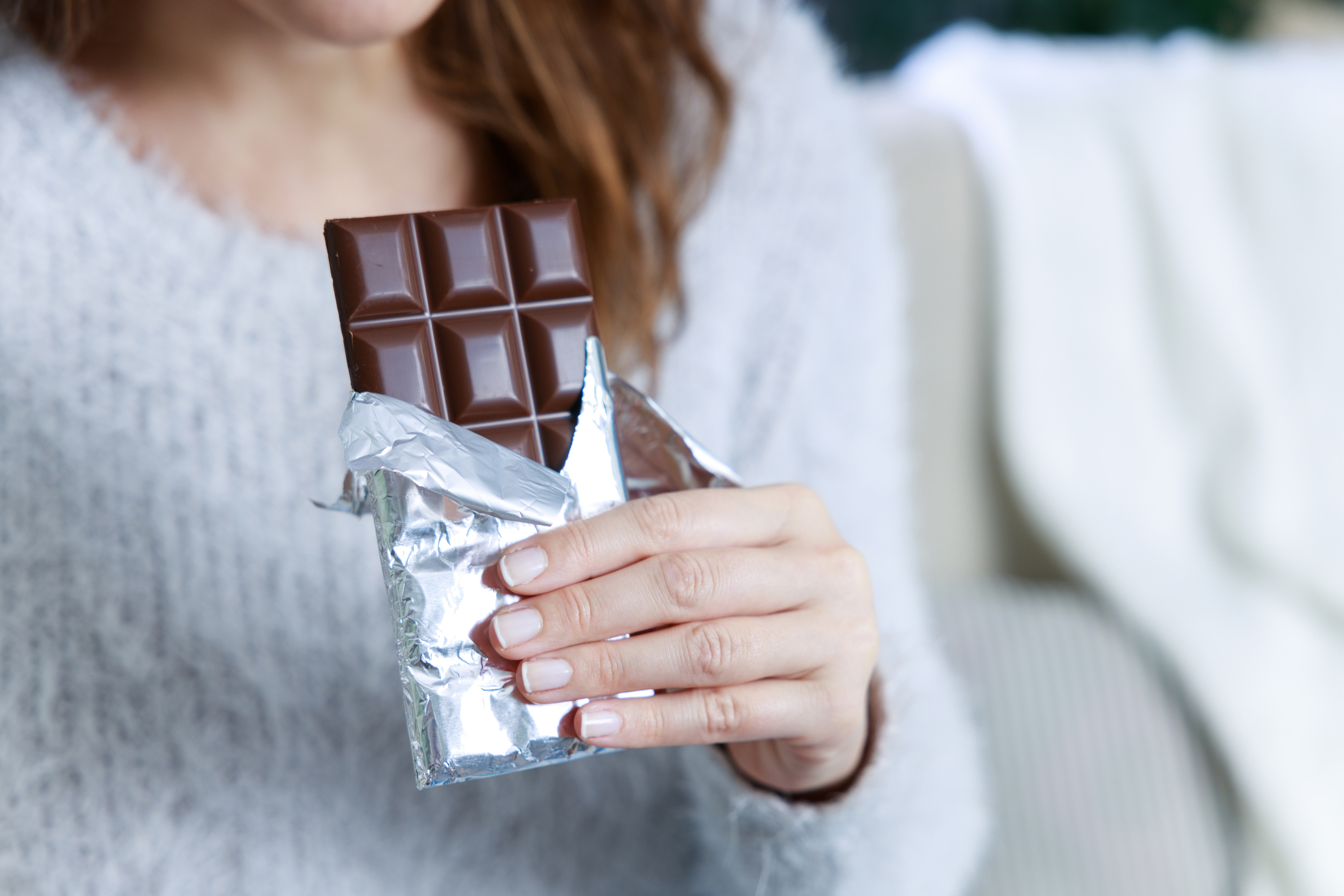 person holding a chocolate bar
