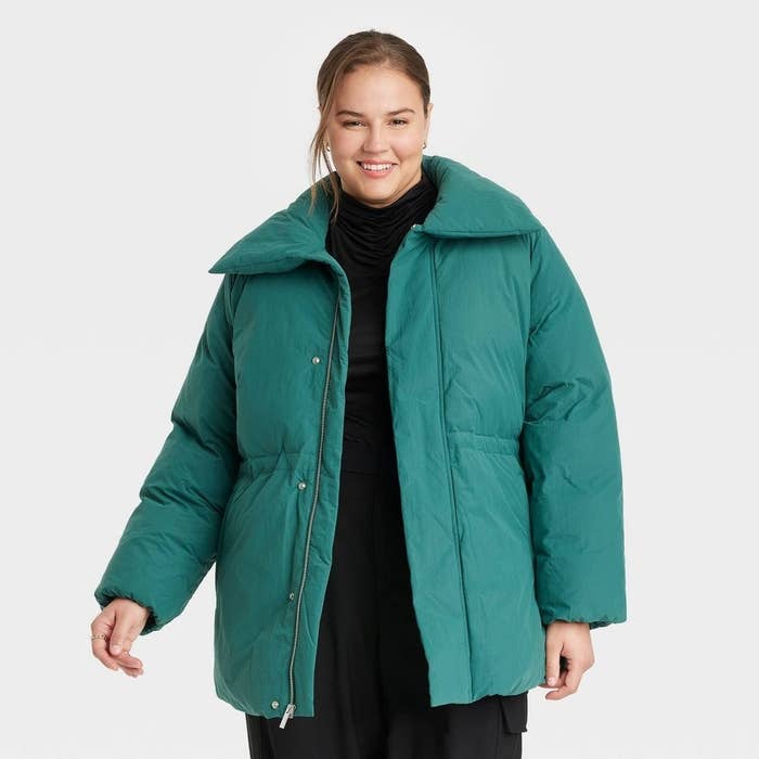 person in a green puffer coat with collar