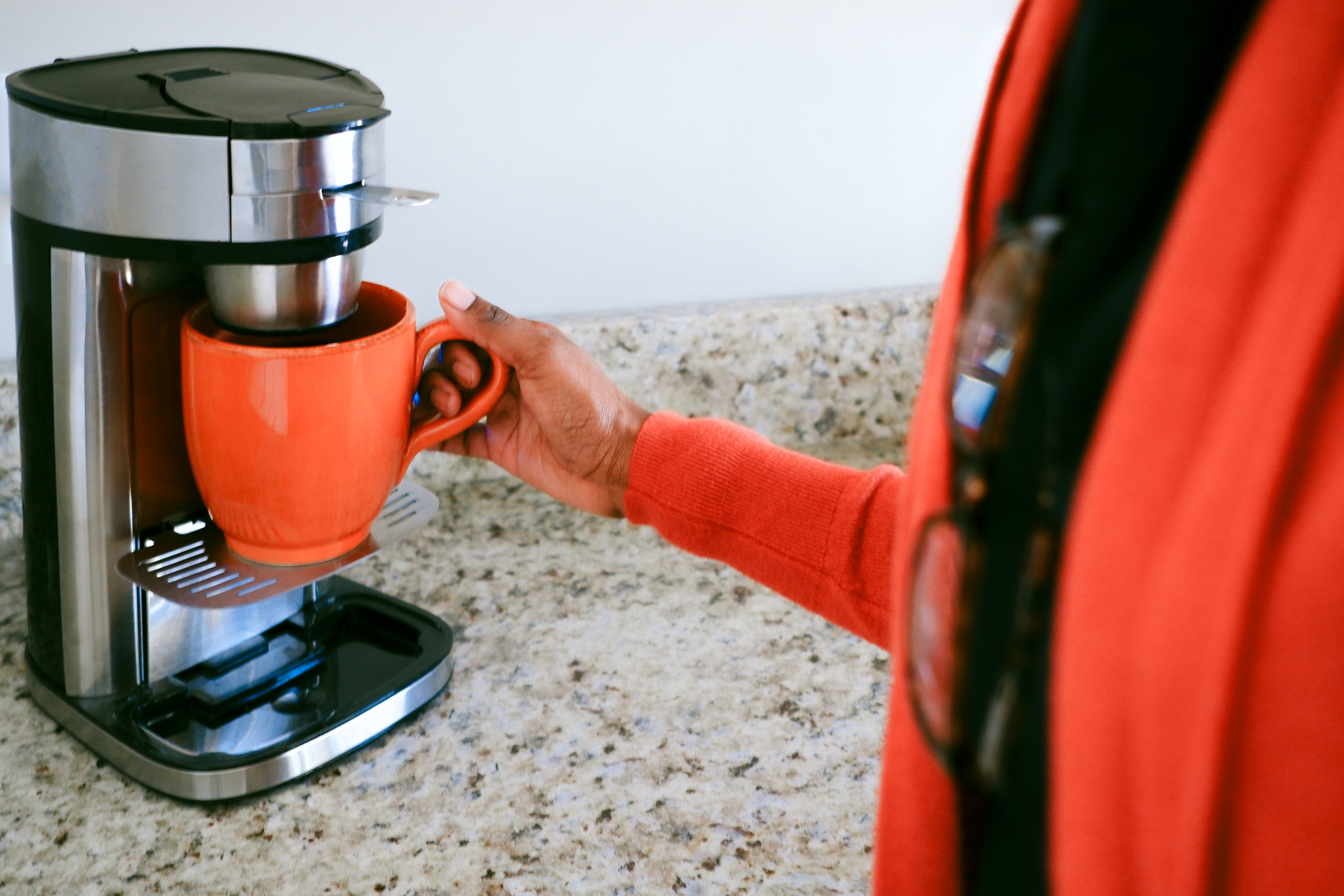 person making a cup of coffee at home