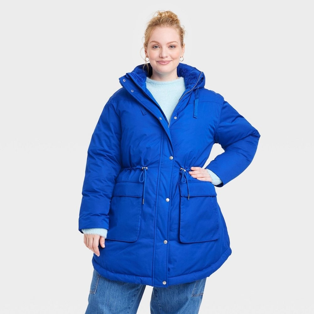 a person wearing a bright blue puffer parka