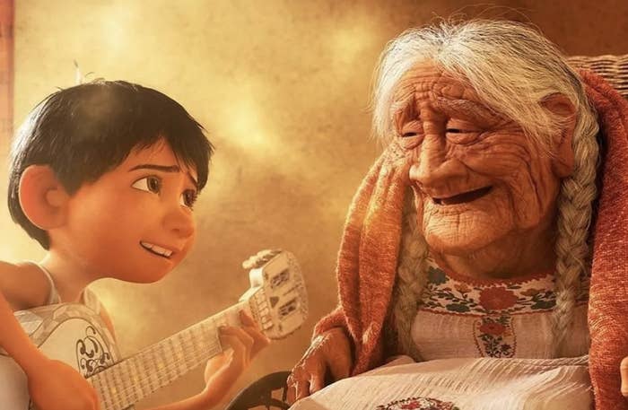 A boy playing guitar for an elderly woman in "Coco"