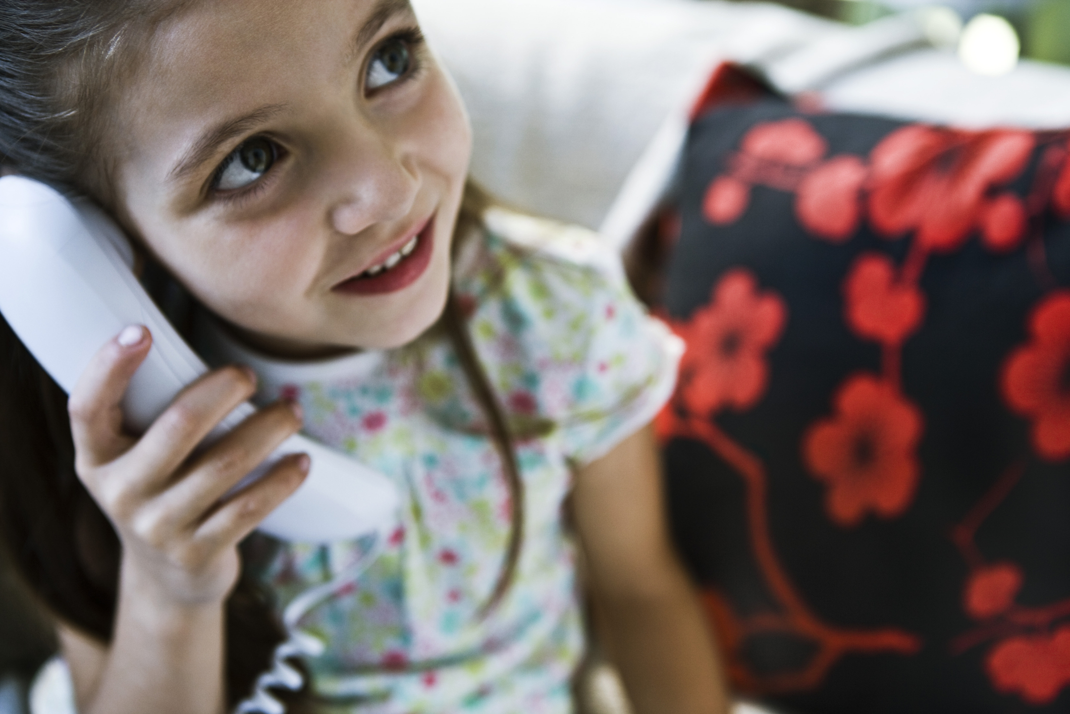 Little girl using landline phone