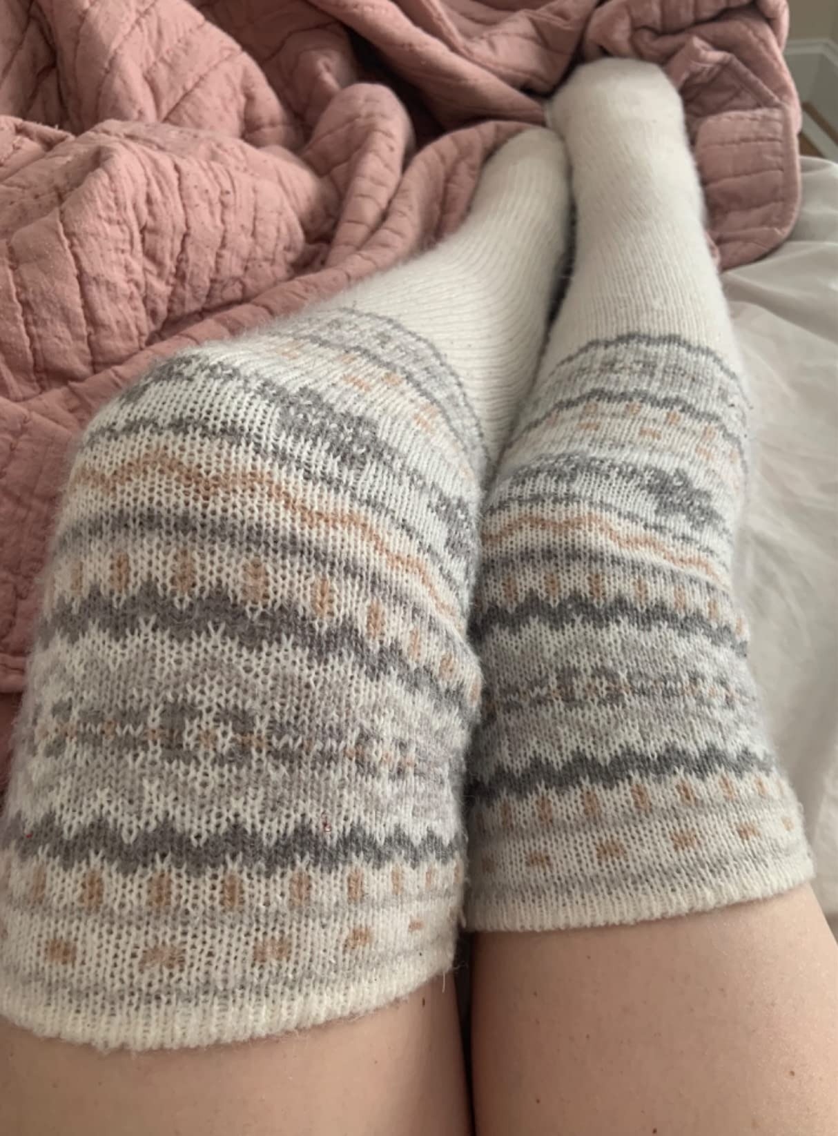 a reviewer photo of legs in the cream and fair isle print socks