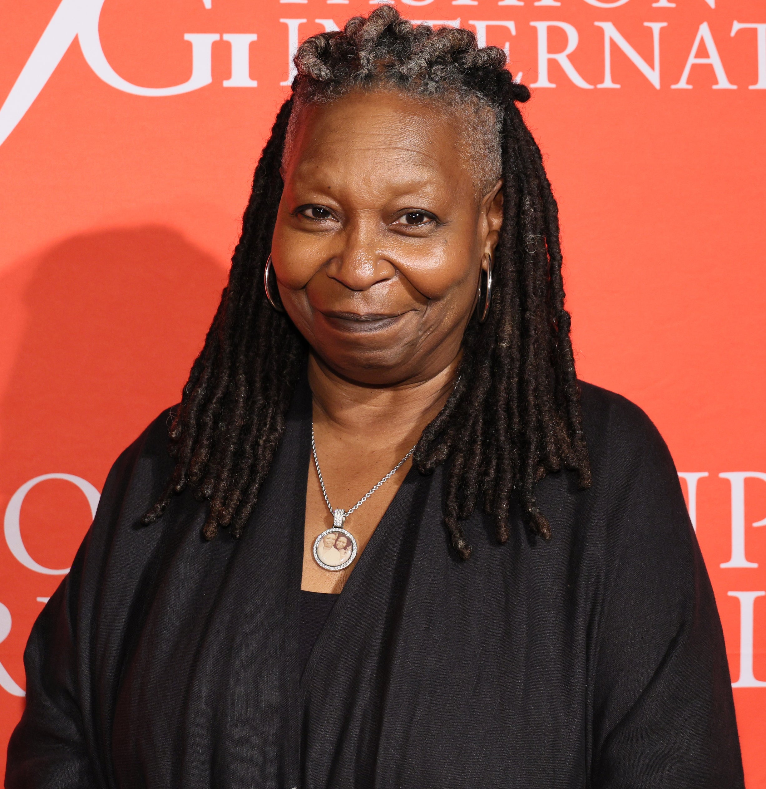 hair in locs with grey showing in the front