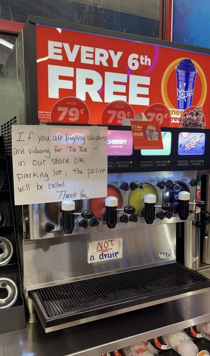 A sign on a soda fountain saying &quot;If you are buying slushies and videoing for TikTok in our store or parking lot, the police will be called&quot;