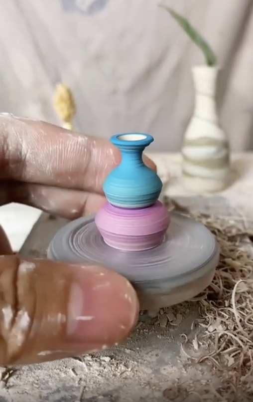 hand constructing a tiny vase