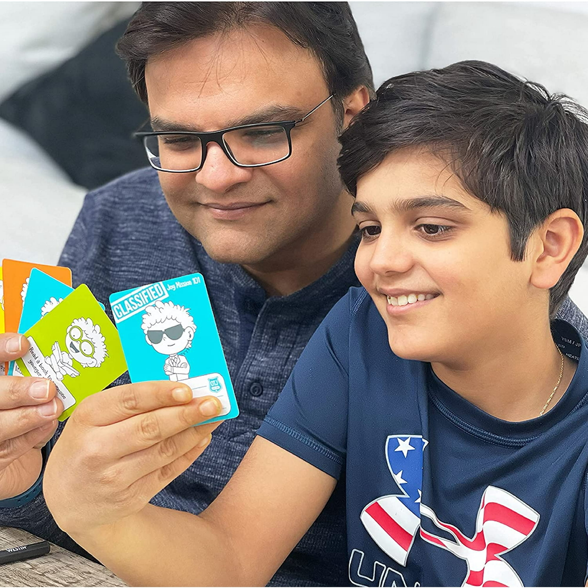 A father and son reading instructions on the cards