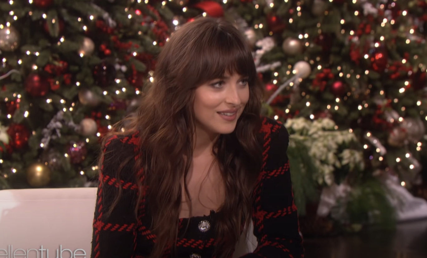 Close-up of Dakota on the show with a Christmas tree behind her