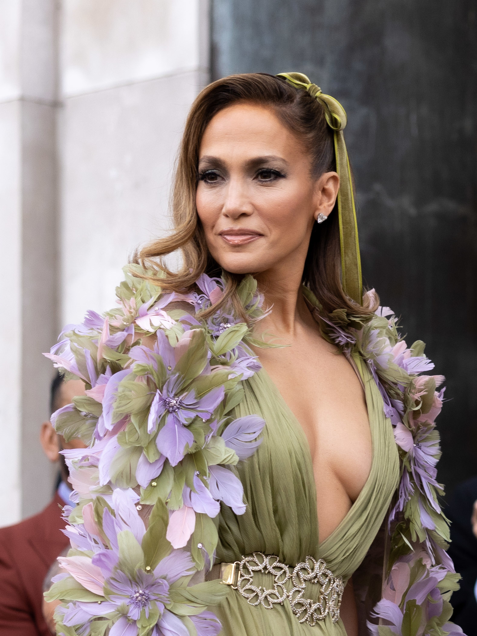 Close-up of JLo in a floral-themed low-cut outfit