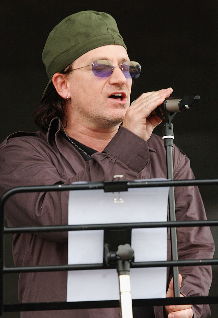 closeup of bono singing in his hat