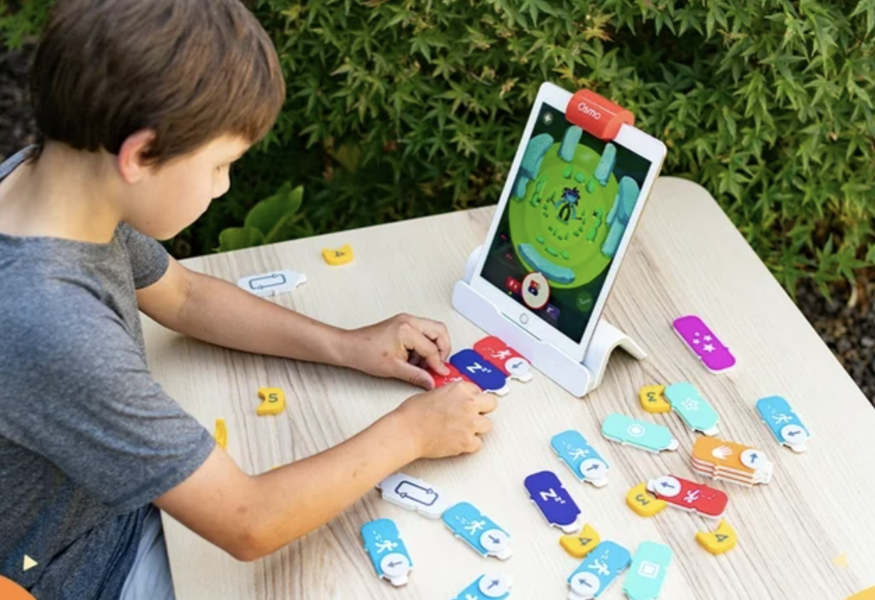 child playing with Osmo Coding Starter Kit for iPad