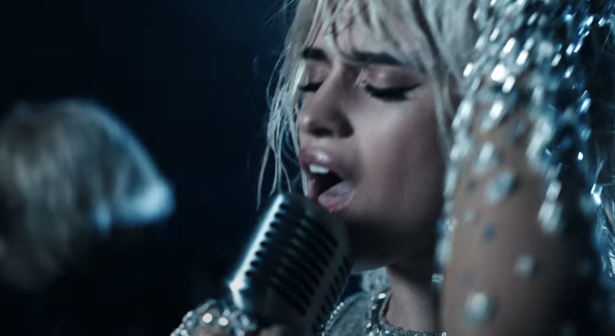 Close-up of Camila singing in the video