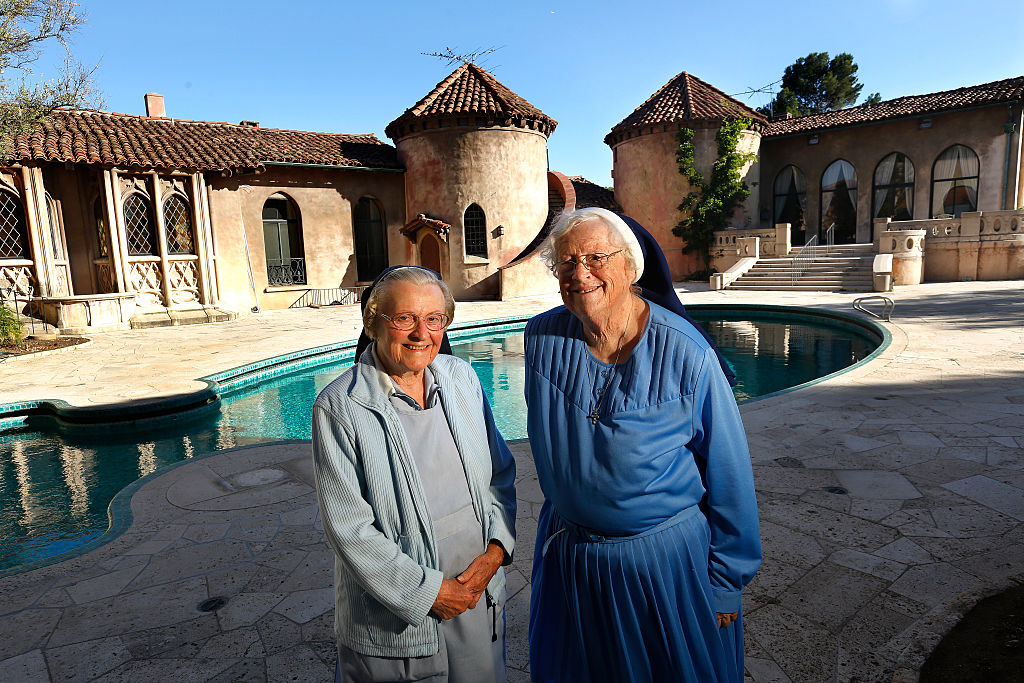 two elder two standing outside the large convent