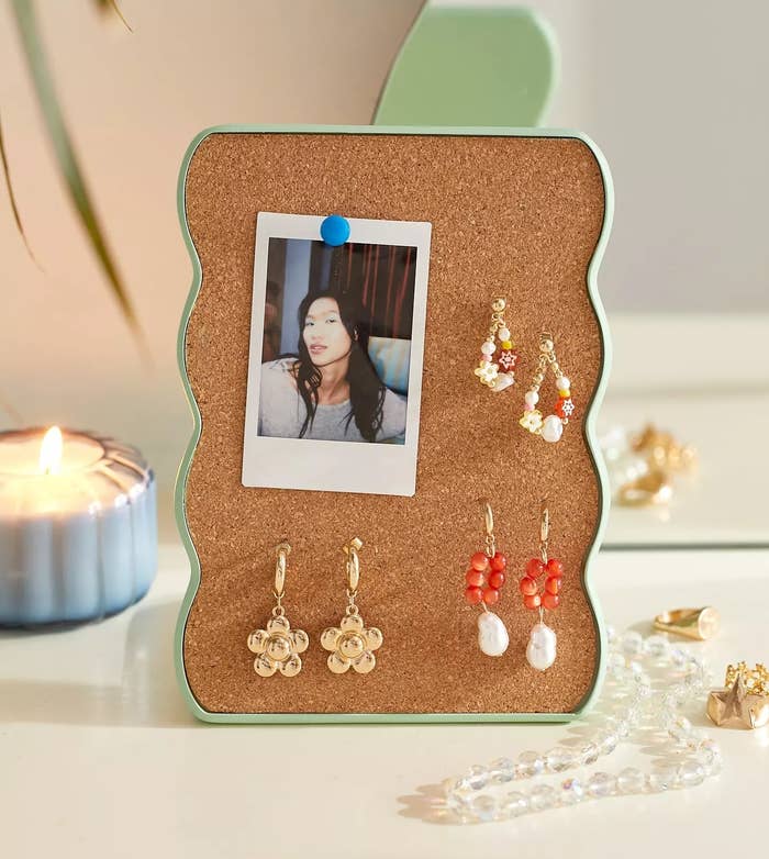 the curvy cork earring holder with a mint green frame