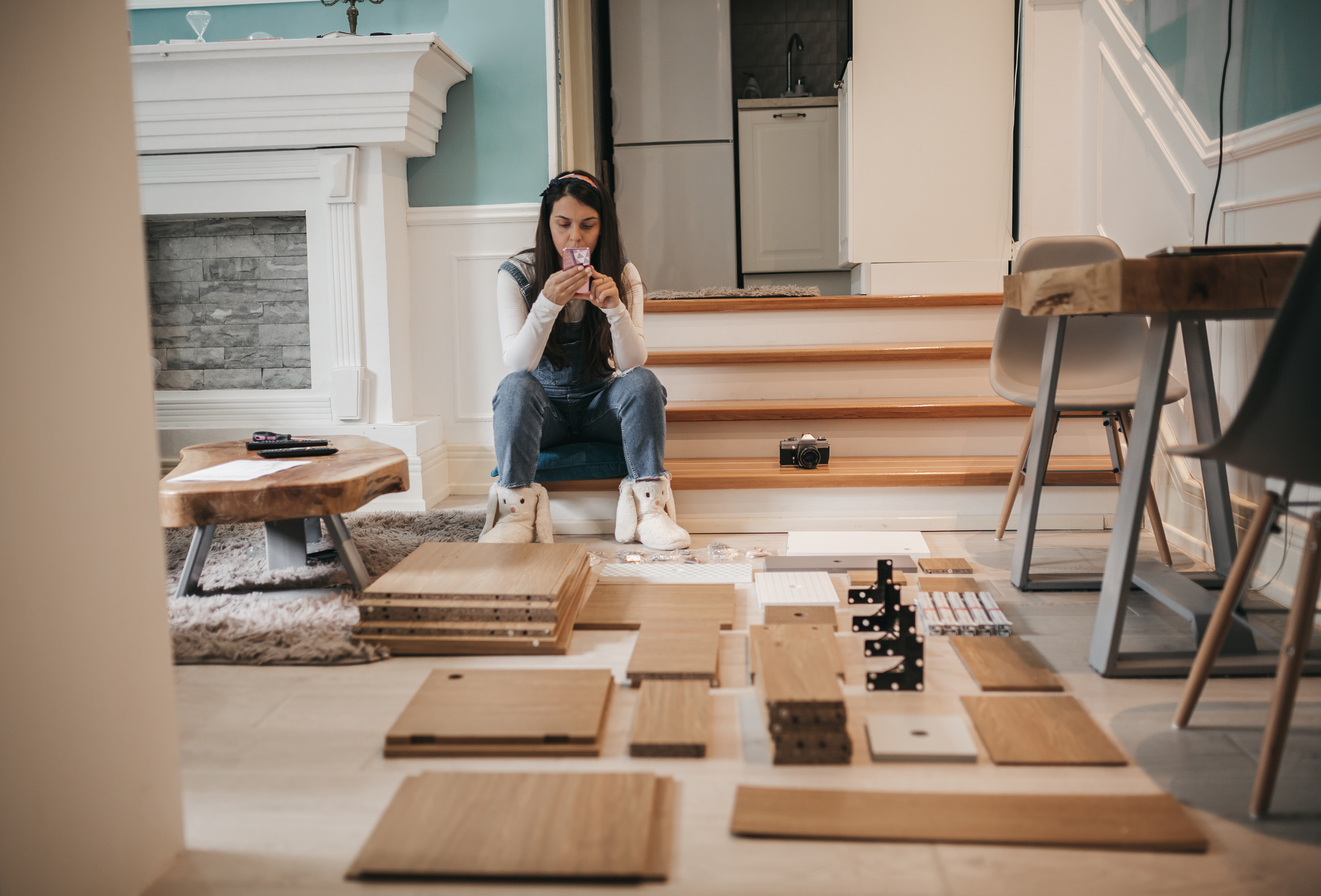 person looking at an unassembled cabinet or furniture piece, stressed