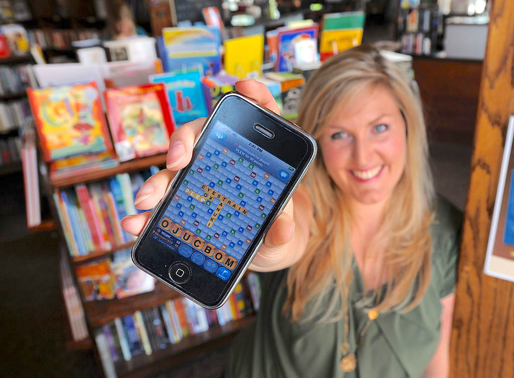 A woman showing Words with Friends on her phone