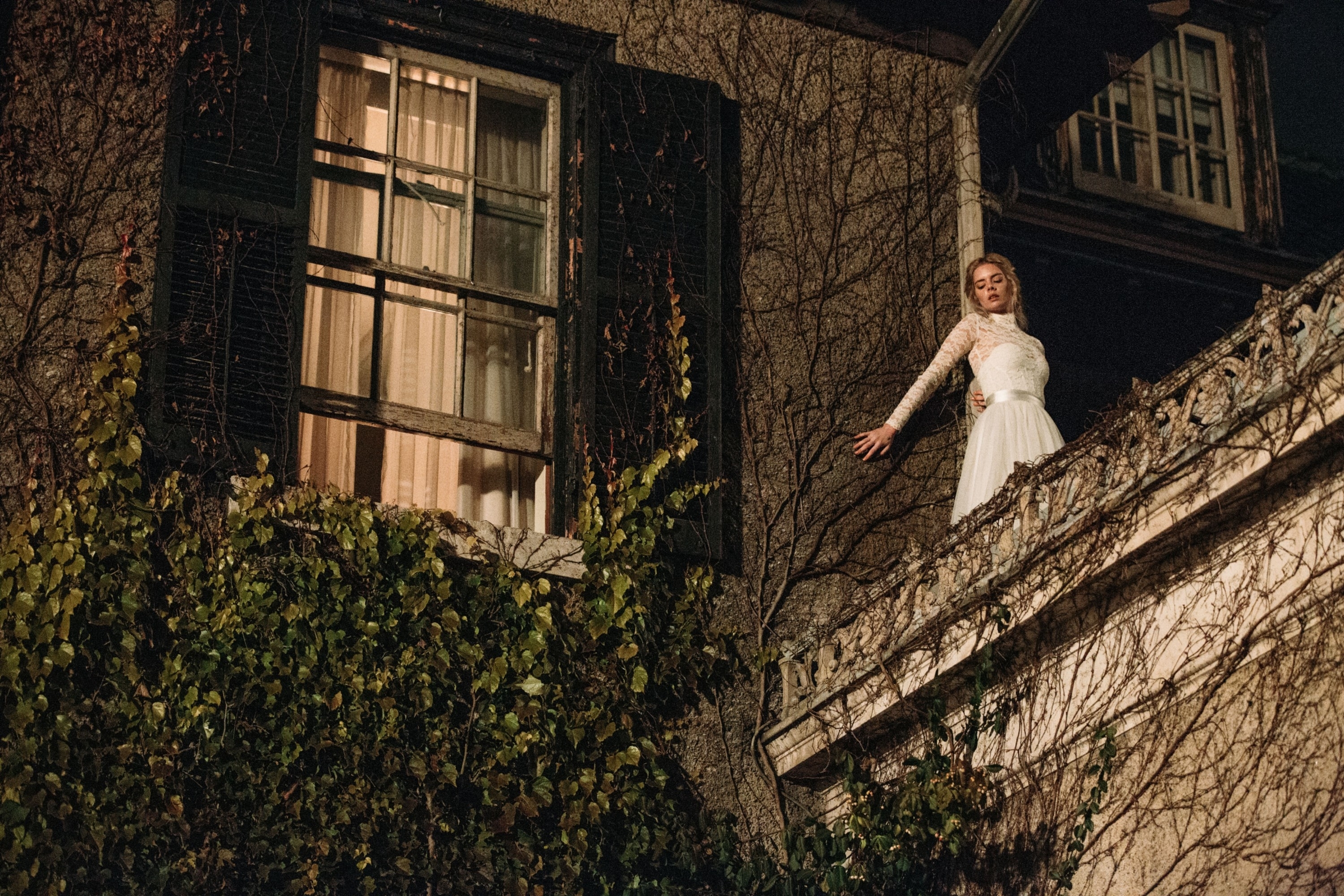 A woman in a wedding dress scaling the side of the building.
