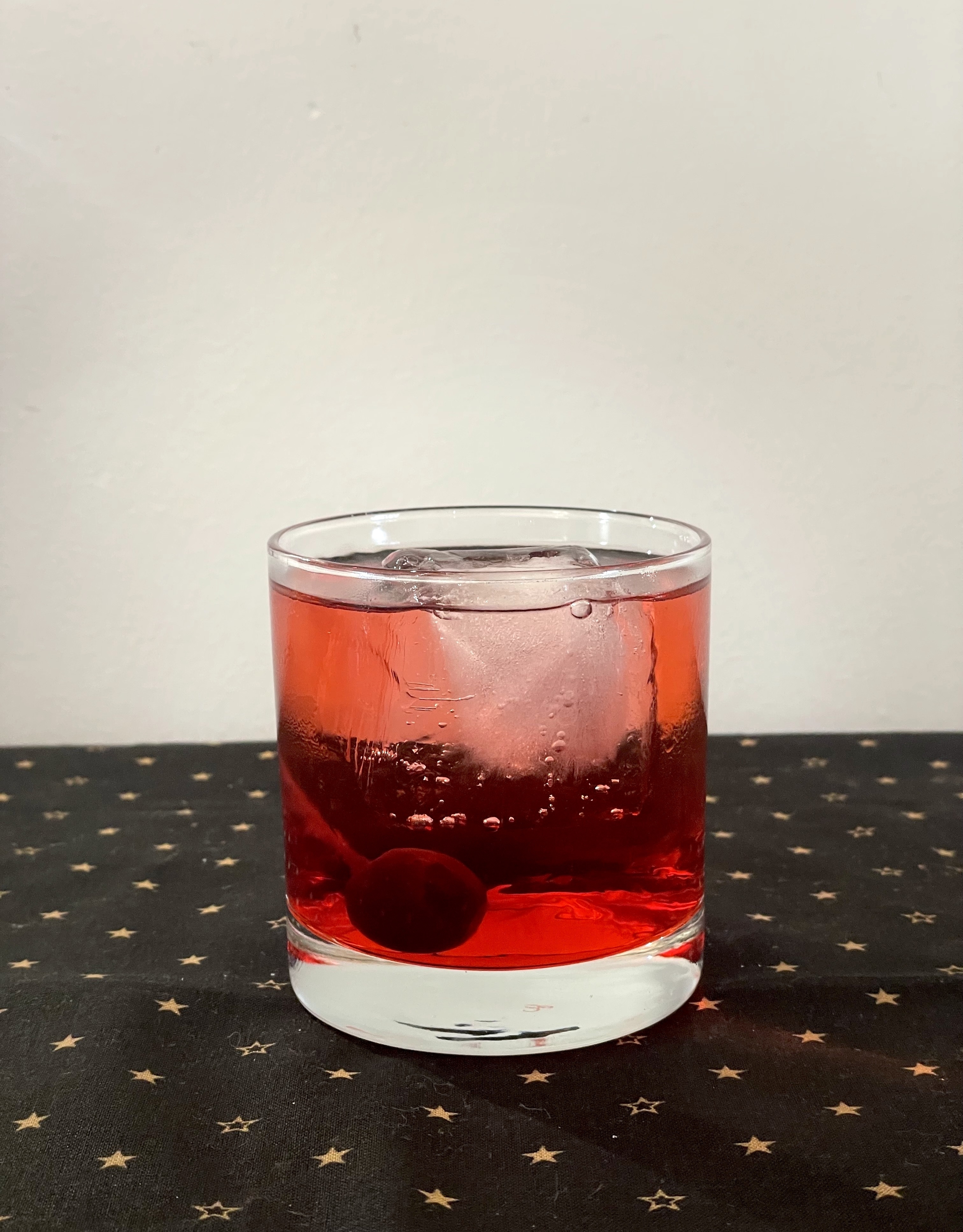 cocktail and cherry in a whiskey glass