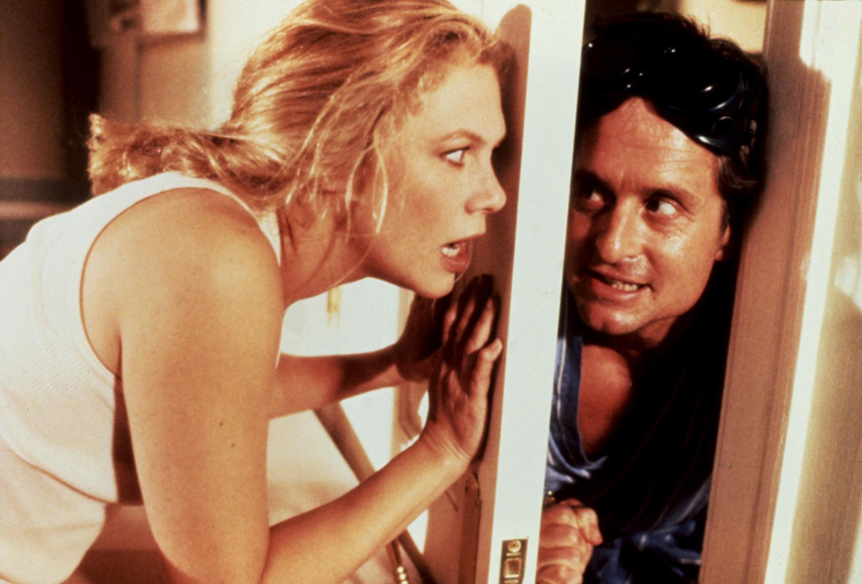 Kathleen Turner and Michael Douglas pushing a door at each other.