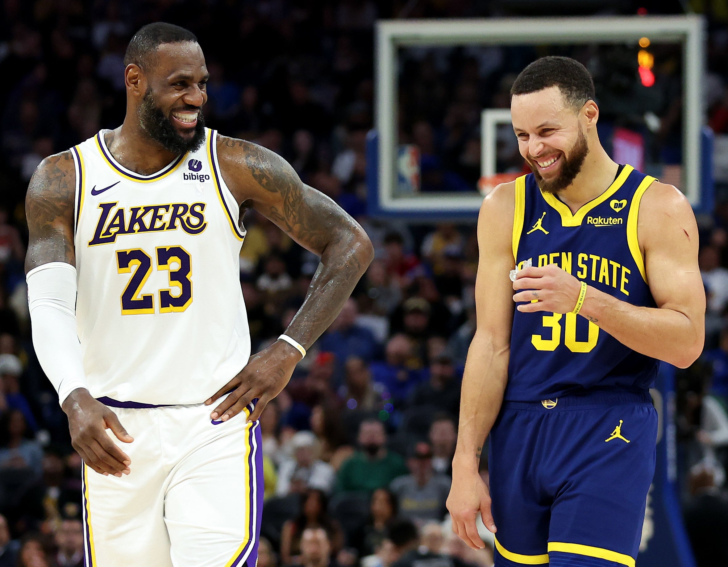 LeBron James and Stephen Curry share a laugh on the basketball court