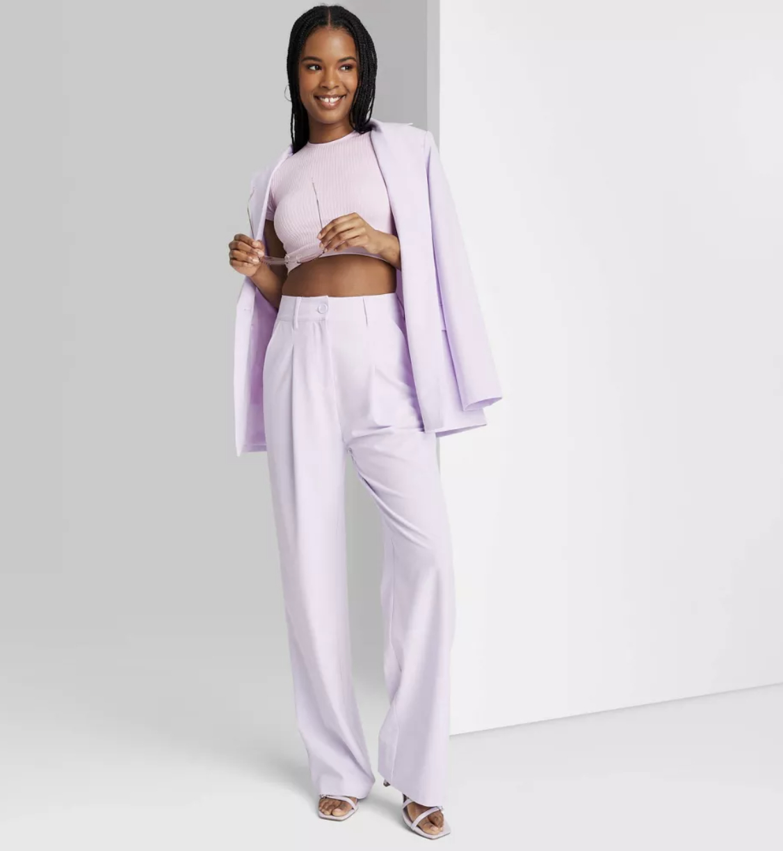 model in a lilac pantsuit with crop top, blazer, and matching pants for shopping article