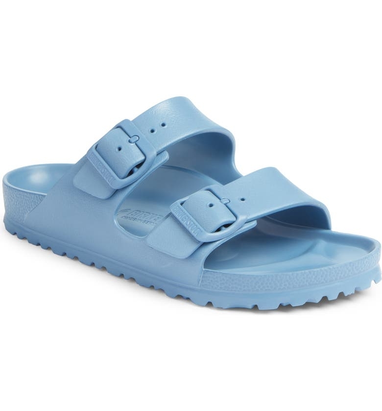 A pair of light blue Birkenstock sandals with adjustable straps