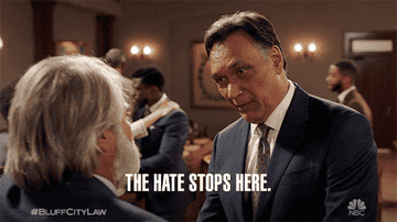 GIF from "Bluff City Law" showing two men in a tense conversation with text "THE HATE STOPS HERE" overlaying the scene
