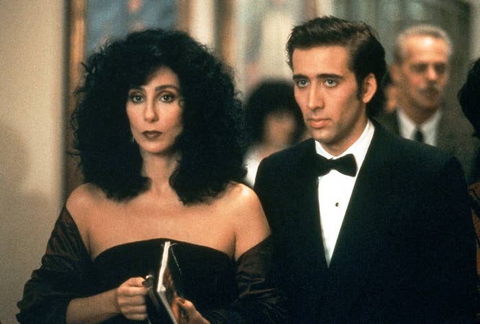 Cher and Nicolas Cage in a scene from the movie &quot;Moonstruck,&quot; dressed in formal attire. Cher holds a purse