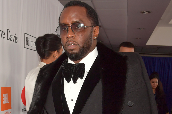 Sean Combs in a black tuxedo with a bow tie at a Clive Davis event