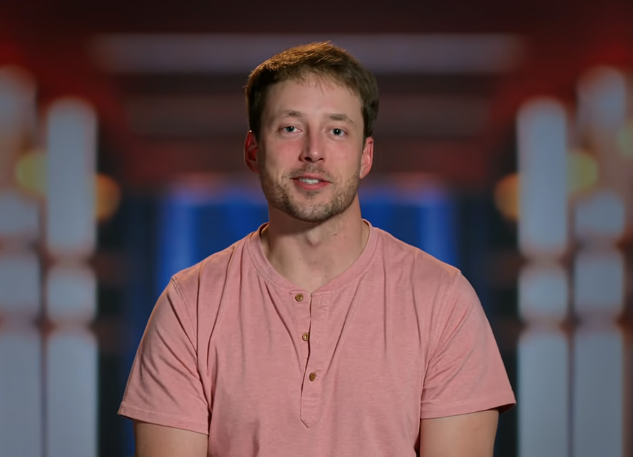 Jeremy in a casual t-shirt smiling at the camera with a blurred background