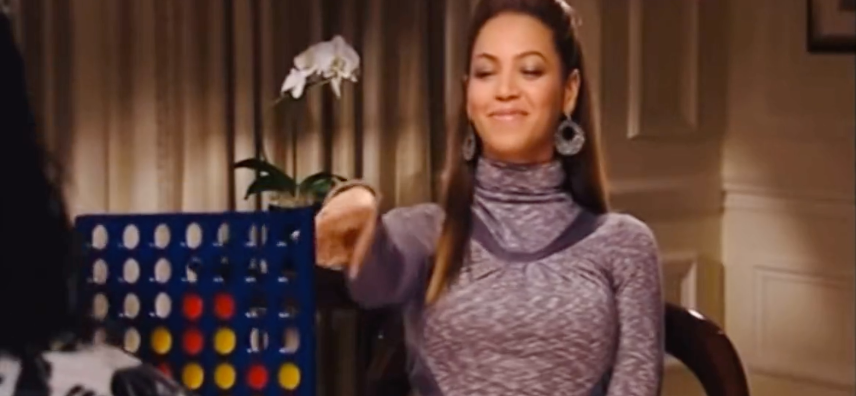 Character in a turtleneck plays Connect Four in a movie scene