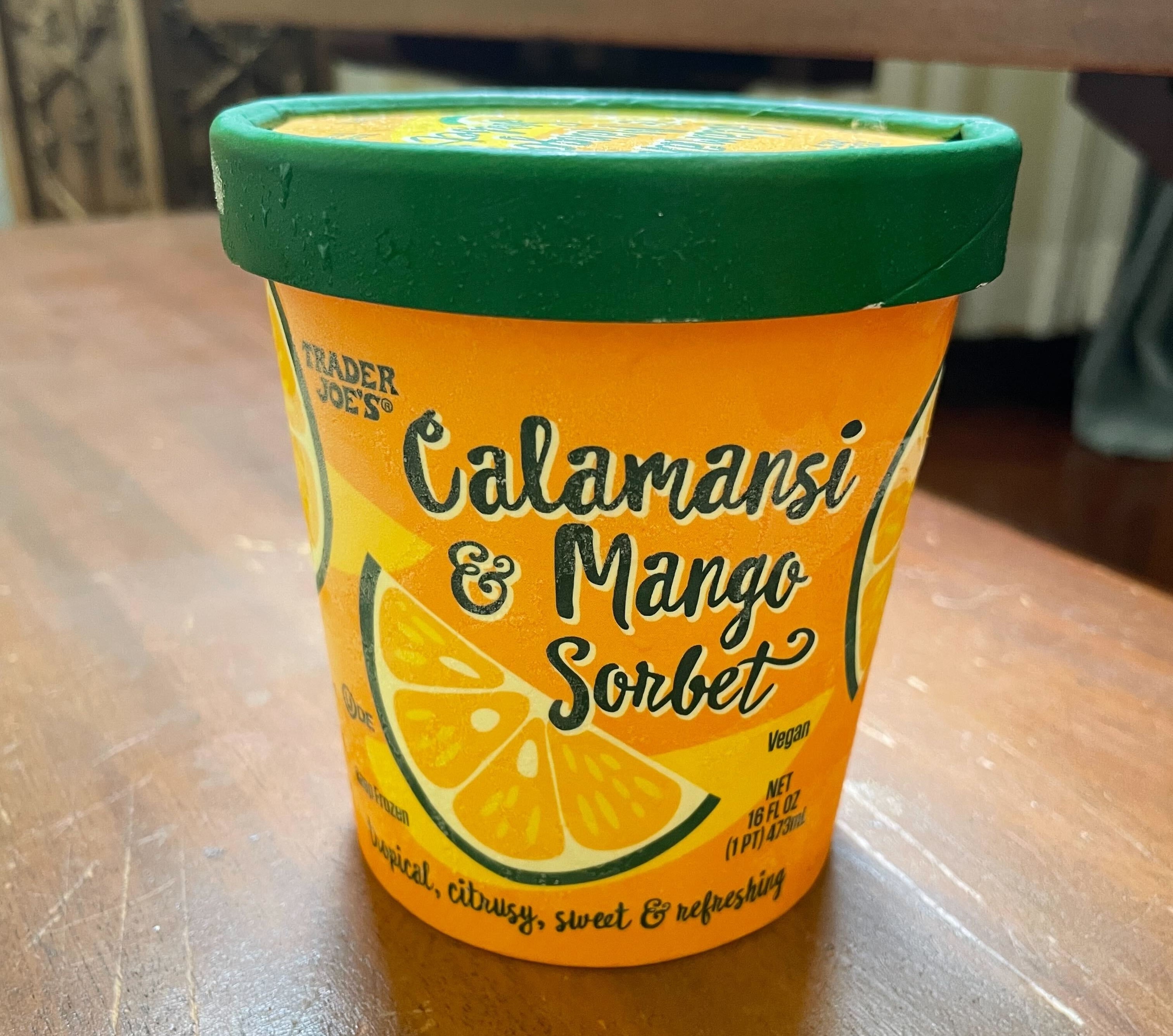 A container of Trader Joe&#x27;s Calamansi &amp;amp; Mango Sorbet on a table