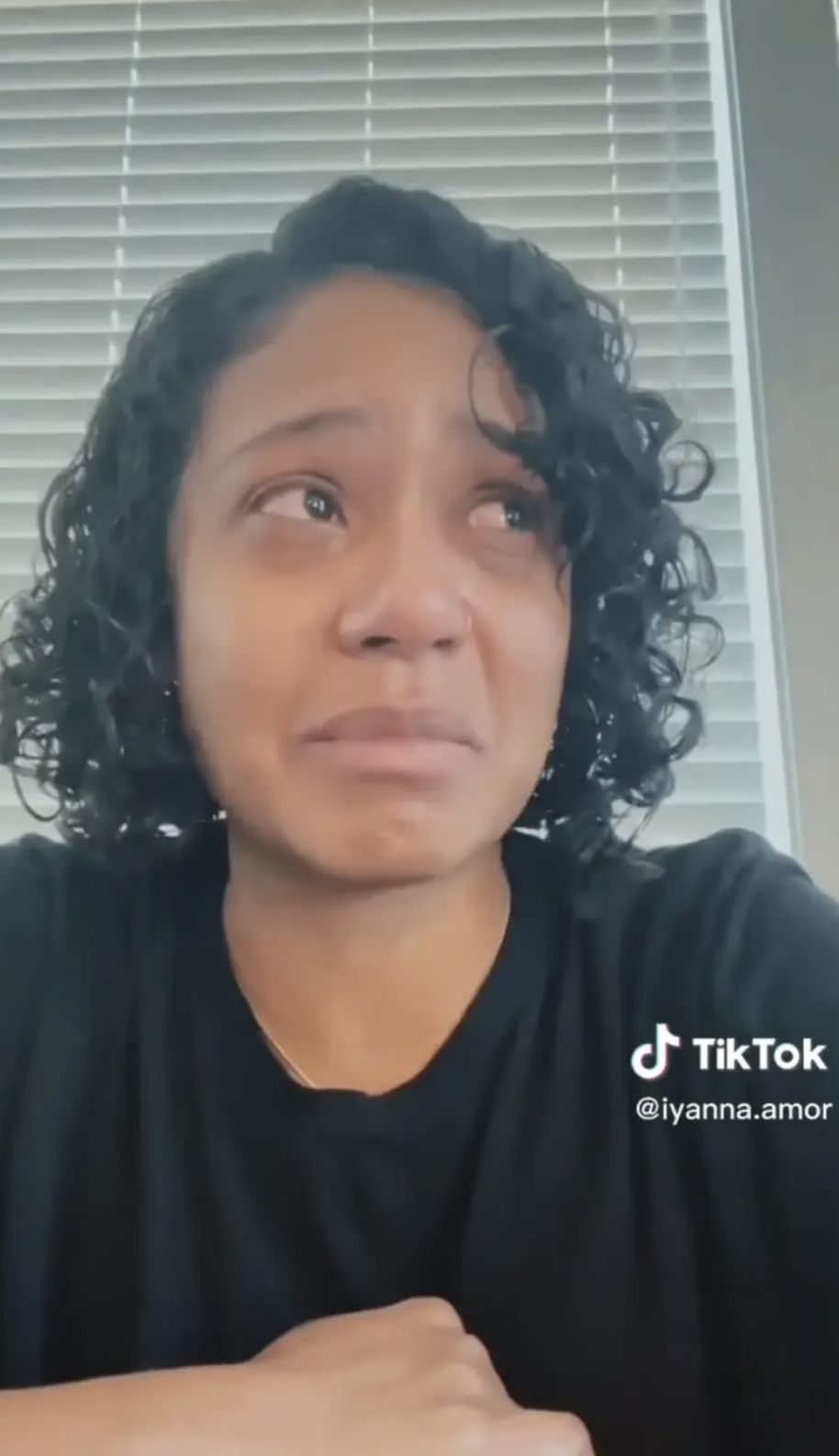 Iyanna McNeely  looks emotional, wearing a t-shirt, with TikTok handle @iyanna.amor visible