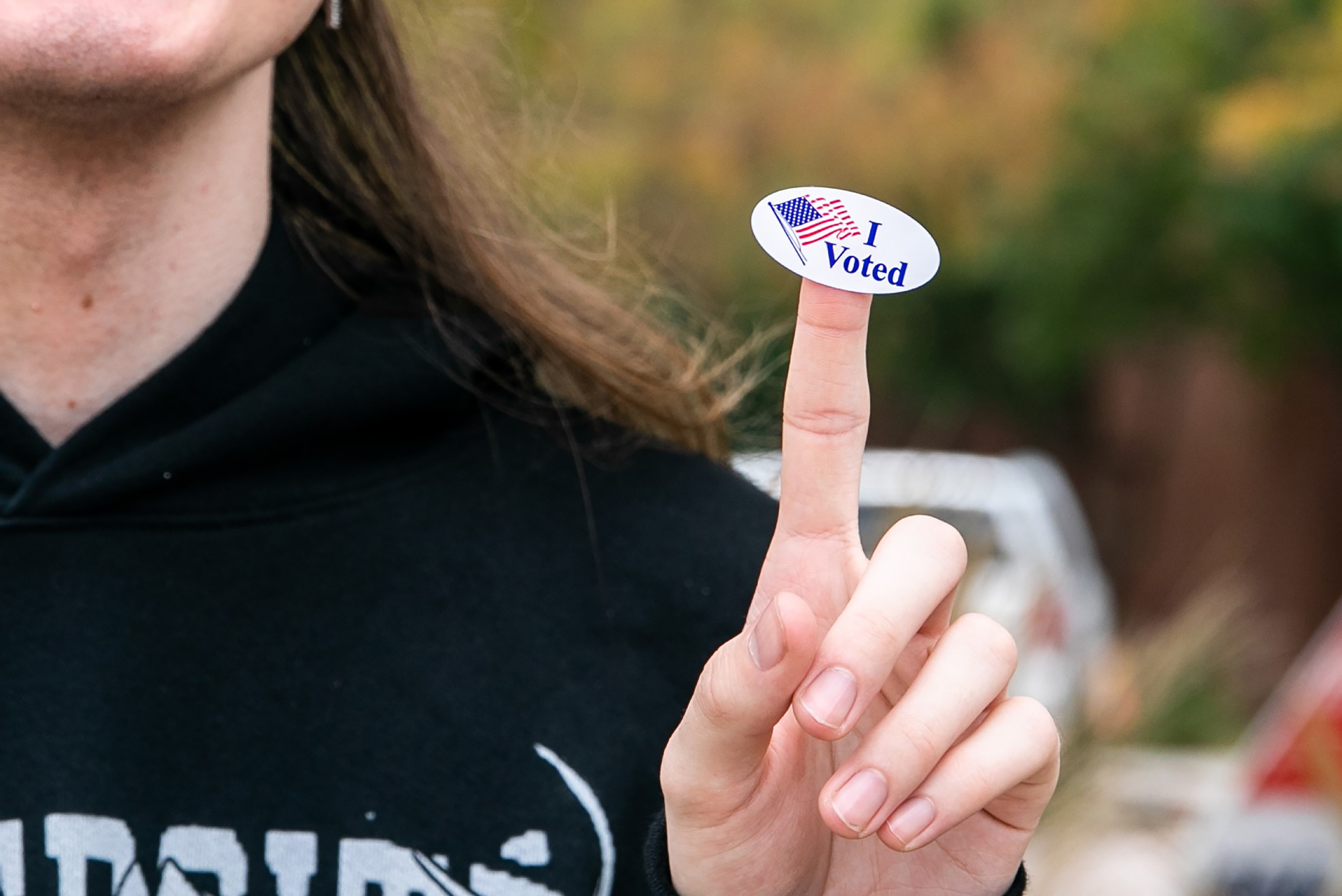 Person showing off an &quot;I Voted&quot; sticker on their index finger