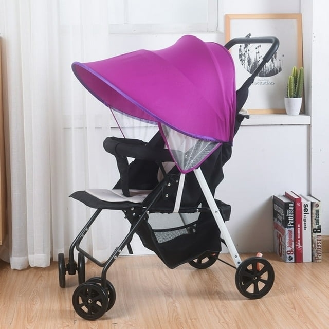 A purple canopy baby stroller with black seat and white frame, displayed in a room setting for shopping context