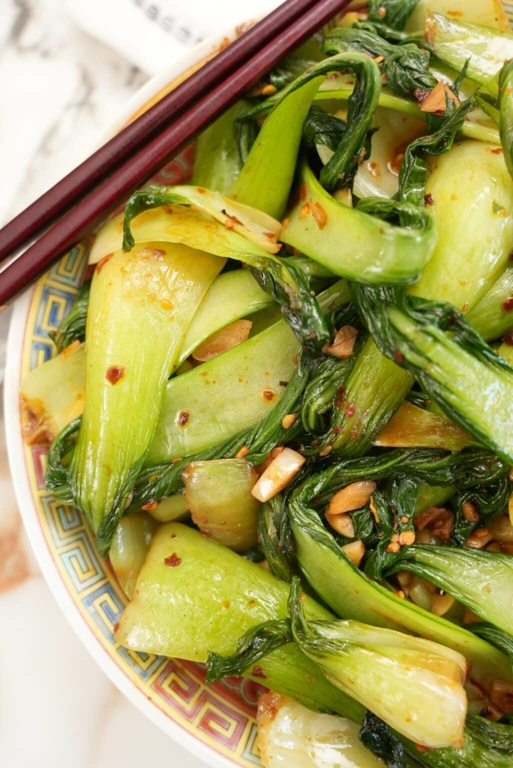Plate of stir-fried bok choy with garlic and chili flakes