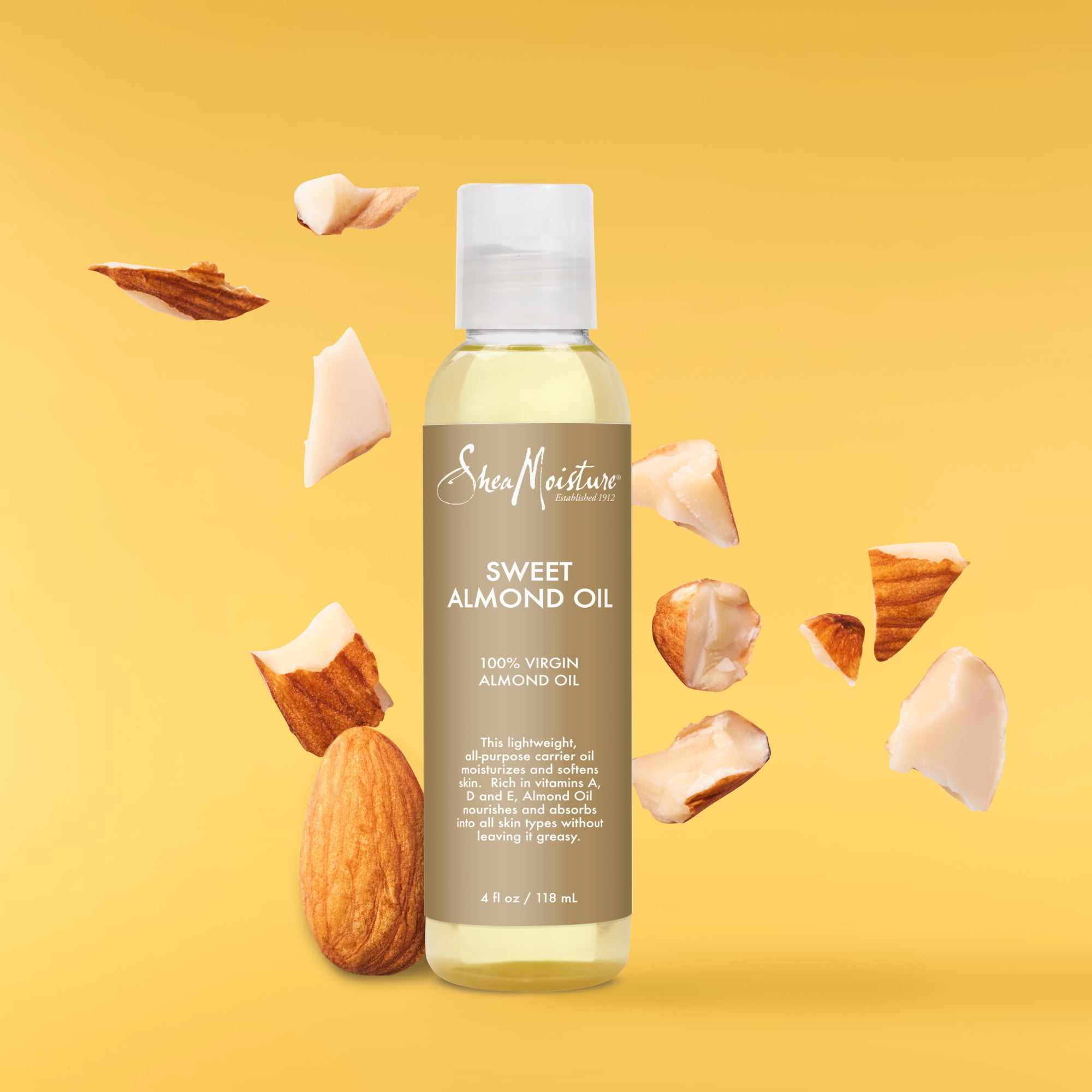 Bottle of Shea Moisture Sweet Almond Oil surrounded by almond pieces on a yellow background