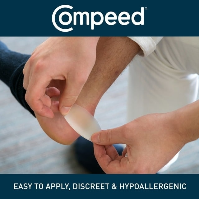 Adhesive bandage being applied to a person&#x27;s heel, with Compeed brand logo and claims of easy application and hypoallergenic properties