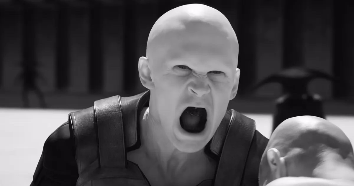 Person in character as an angry, bald figure in a leather vest, with a blurred background
