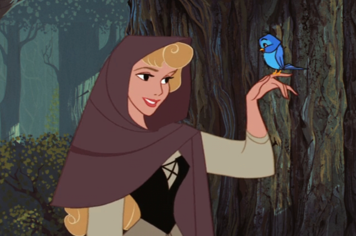 Princess Aurora from Sleeping Beauty smiling at a blue bird perched on her finger in the forest