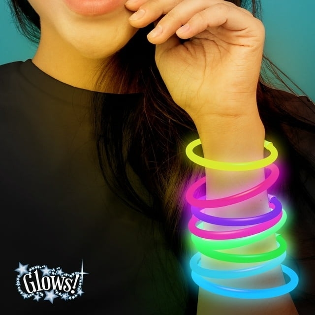 Person wearing glowing bracelets on one arm, text: &quot;Glows!&quot; indicates the product feature