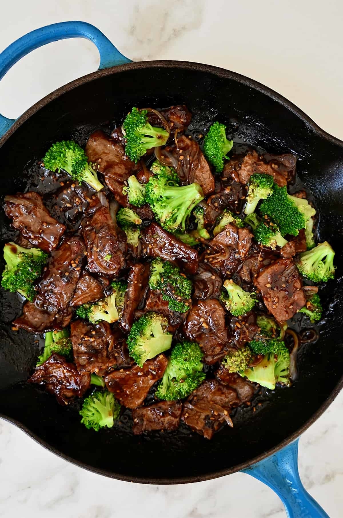 Skillet with beef and broccoli dish, cooked and ready to serve