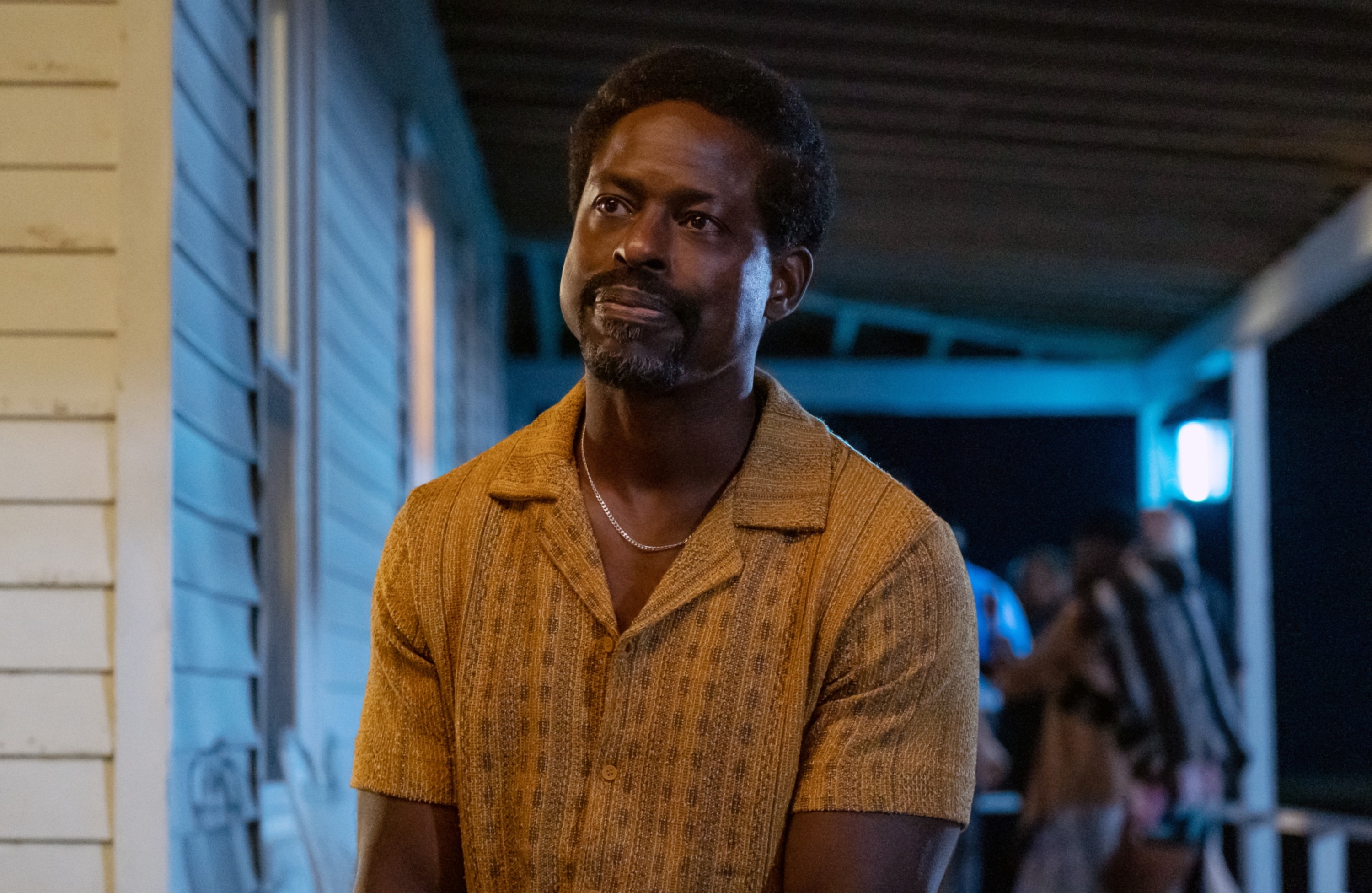 Sterling K Brown in a patterned shirt portraying a character in a TV show scene