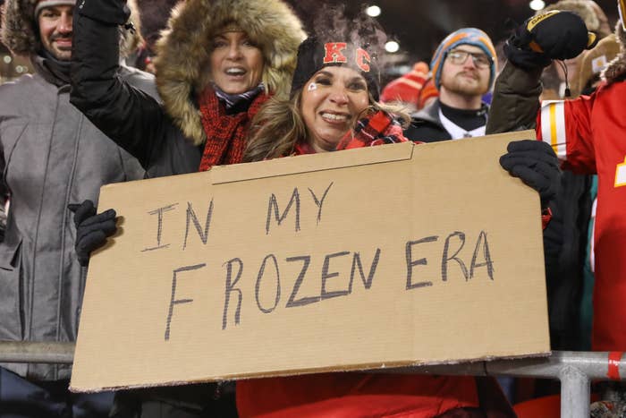 A fan holds a sign reading &quot;IN MY FROZEN ERA&quot; at a sports event, surrounded by other cheering fans
