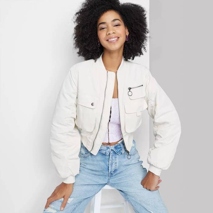 A model in the white cargo bomber jacket